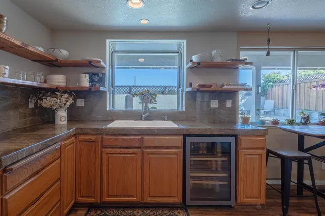 a kitchen with kitchen island granite countertop a sink and cabinets