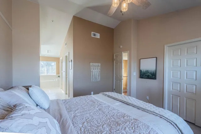 a bedroom with a bed and a chandelier