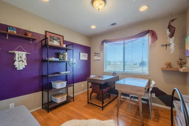 a view of a workspace with furniture and a window
