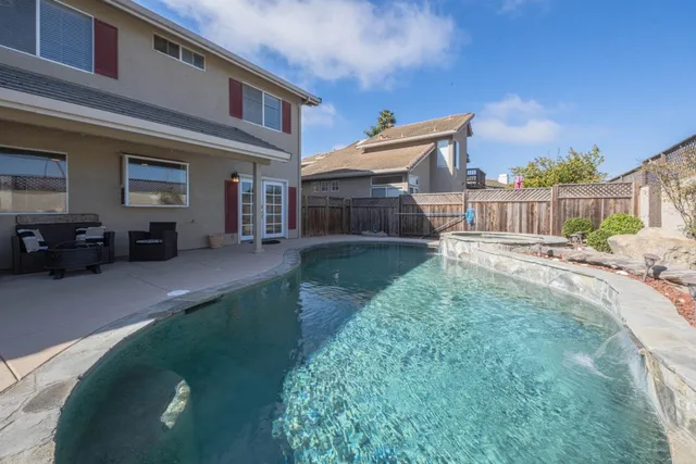 a view of a livingroom with lounge chair and windows