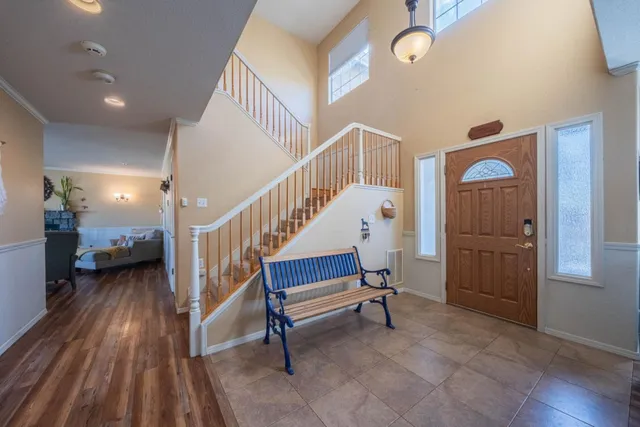 a view of entryway room and hall with wooden floor