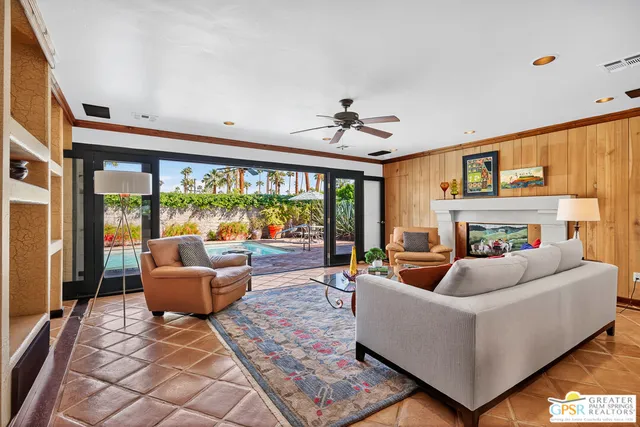 a living room with furniture fireplace and rug