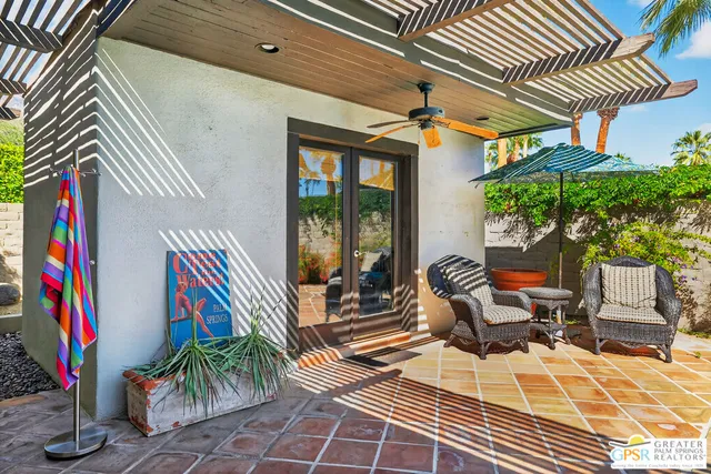 a living room with patio furniture and a fireplace