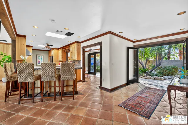 a very nice looking room with a large window and potted plants