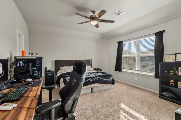 a bedroom with furniture and a window