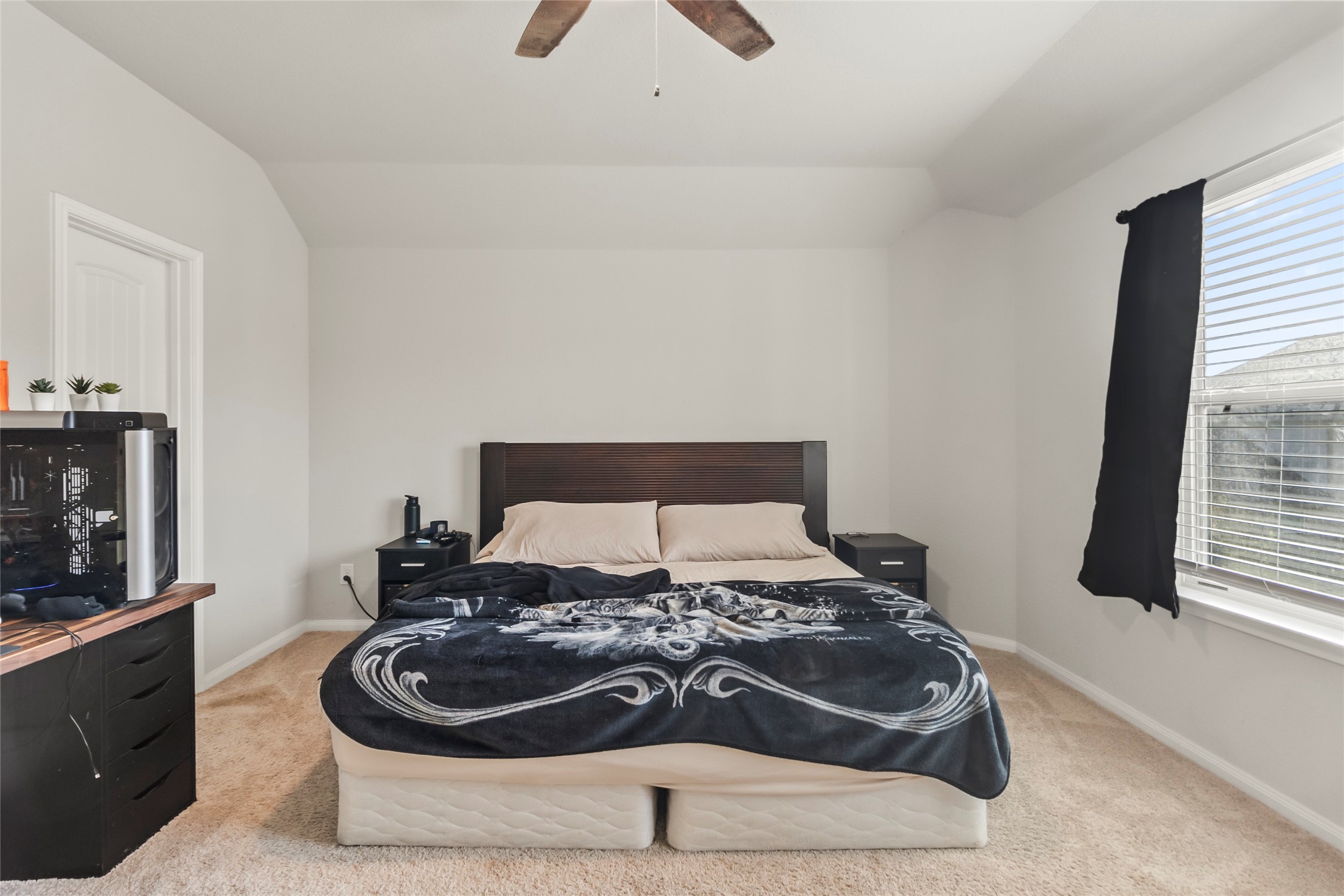 4831 Blue Jacaranda Way Spring, TX 77373 - Photo 13 of 24 a bed sitting in a bedroom next to a window with a dresser