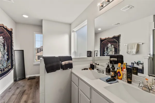 a bathroom with a bathtub sink and mirror