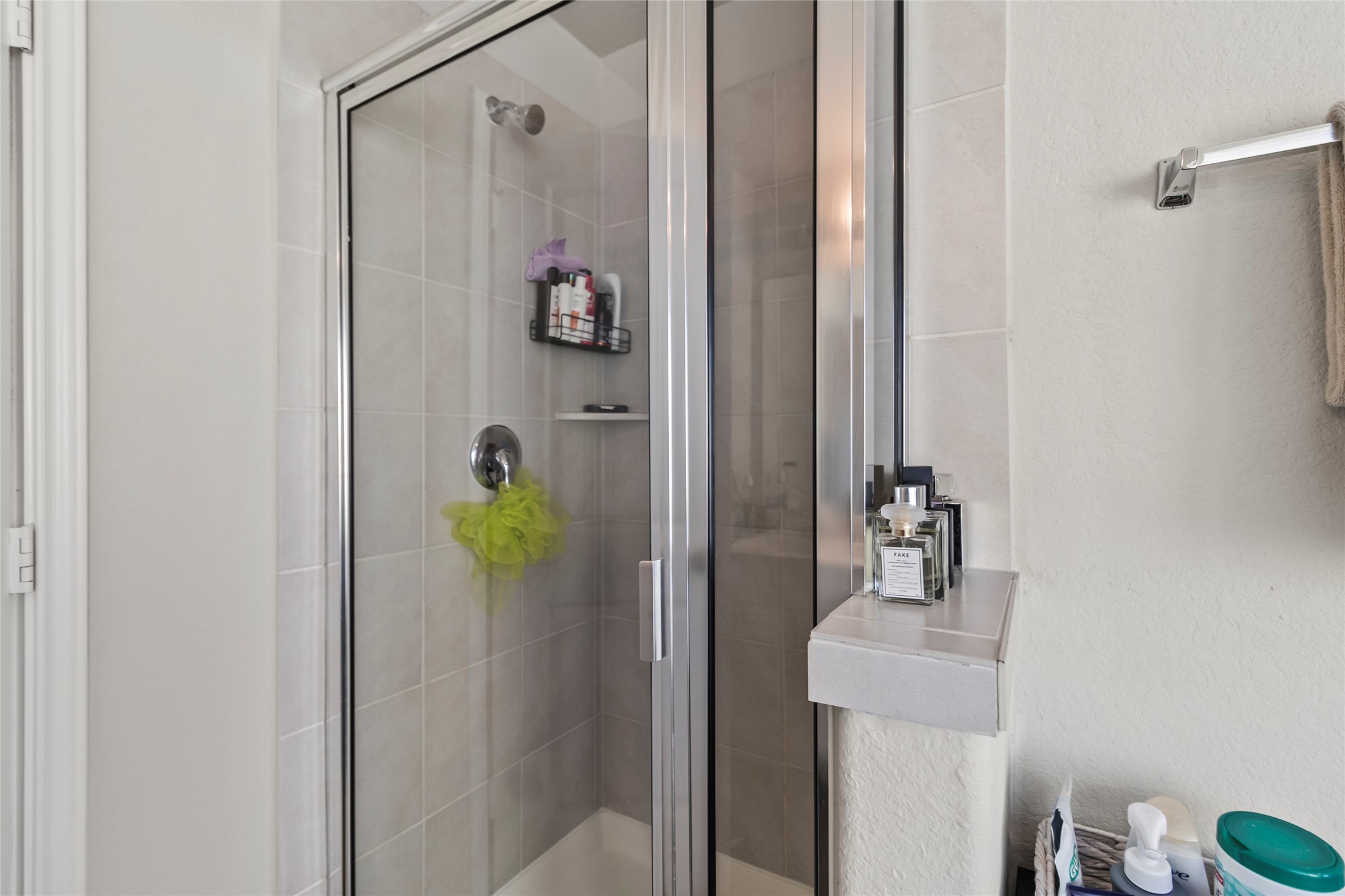 4831 Blue Jacaranda Way Spring, TX 77373 - Photo 16 of 24 a bathroom with a shower and mirror