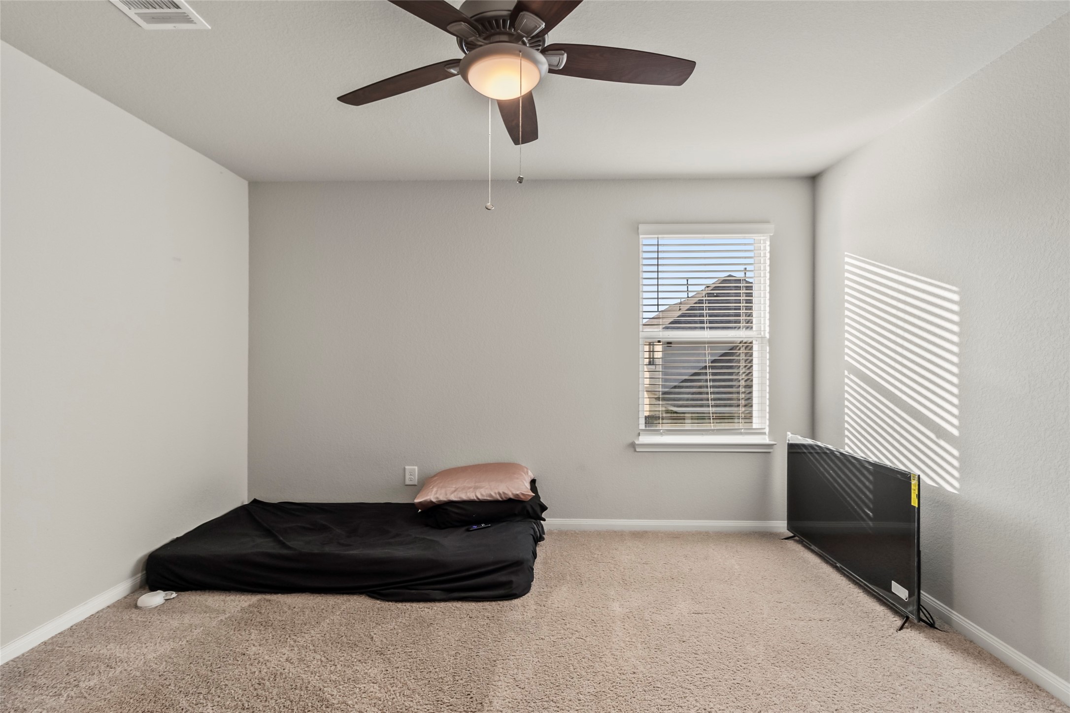 4831 Blue Jacaranda Way Spring, TX 77373 - Photo 20 of 24 a bedroom with a bed and a window