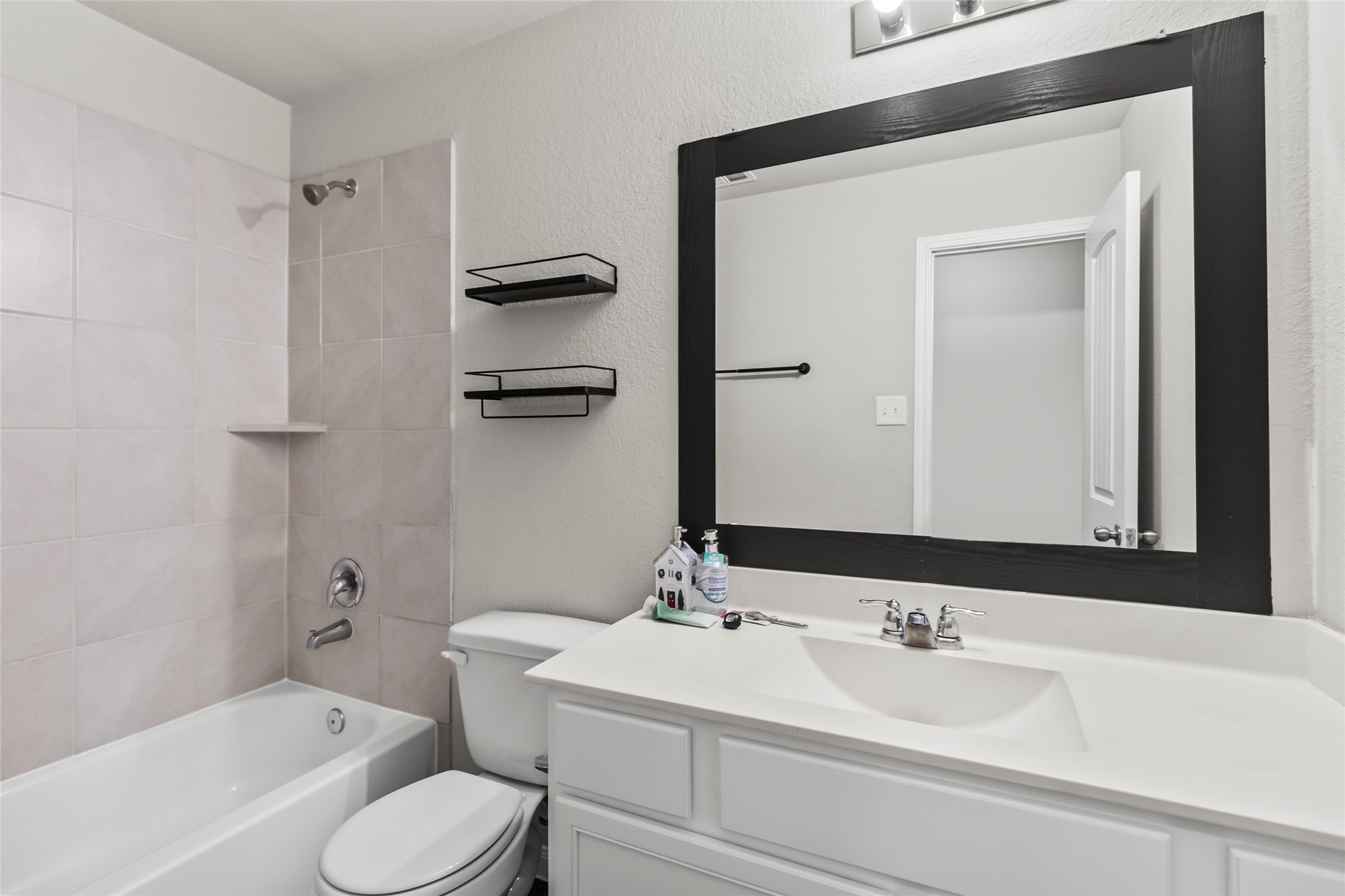 4831 Blue Jacaranda Way Spring, TX 77373 - Photo 21 of 24 a bathroom with a toilet a sink and a bathtub