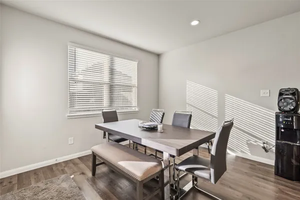 a view of a dining room with furniture and wooden floor