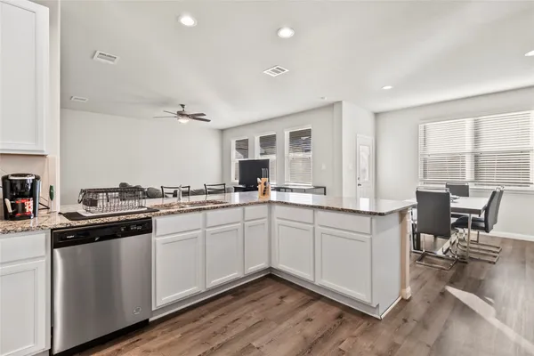 a kitchen with sink cabinets and wooden floor