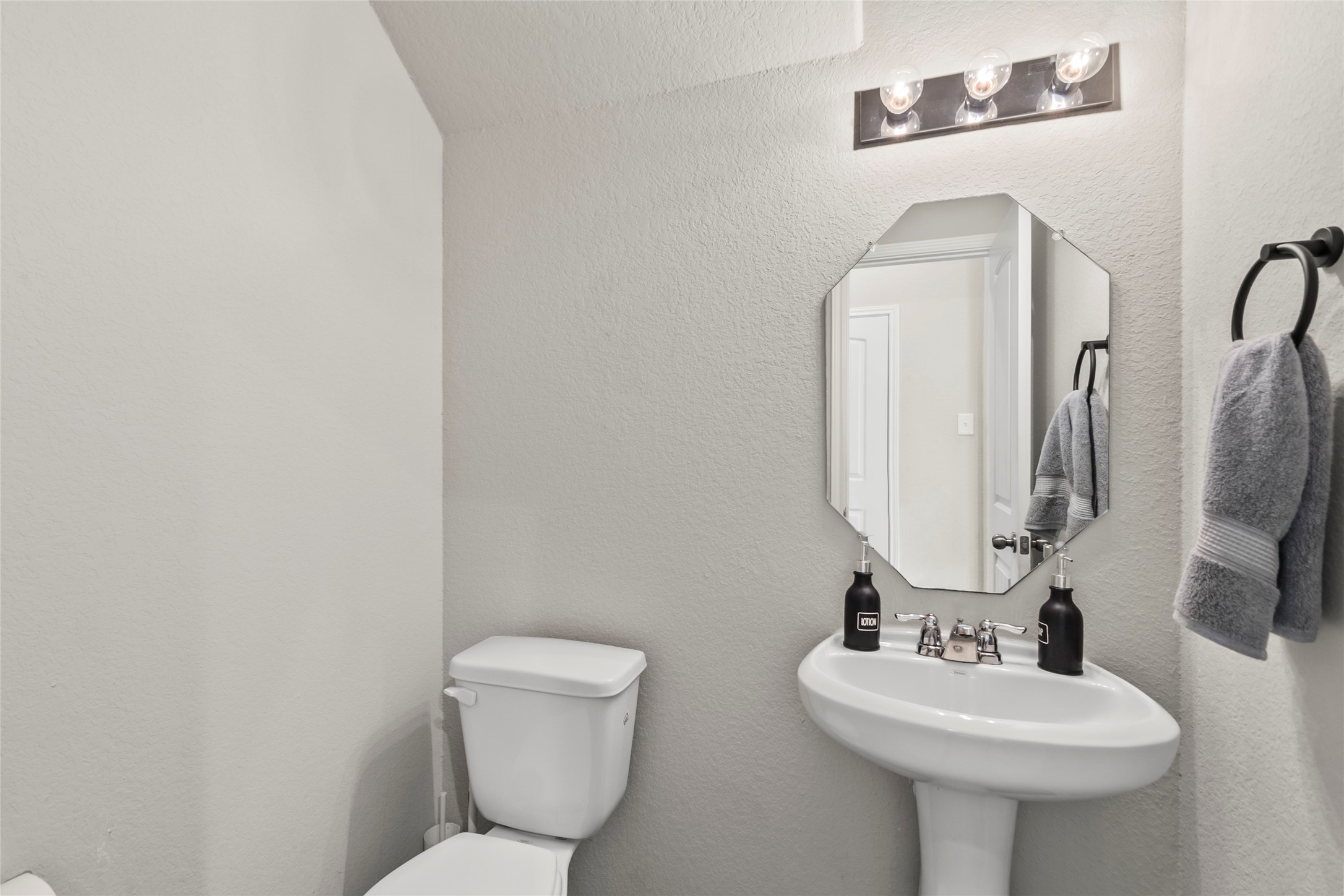 4831 Blue Jacaranda Way Spring, TX 77373 - Photo 9 of 24 a bathroom with a toilet sink and mirror