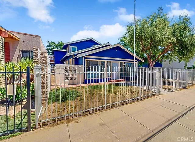 a view of a wrought iron fences in front of house