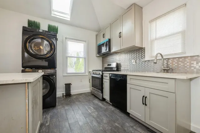 a kitchen with a stove top oven sink and cabinets