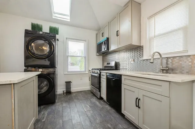 a kitchen with a stove top oven sink and cabinets