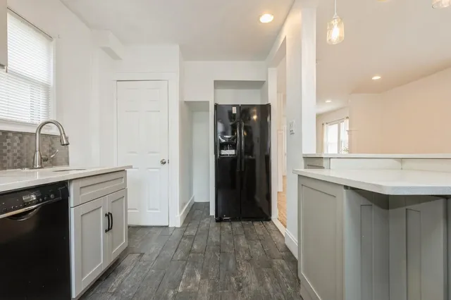 a kitchen with a refrigerator and a sink