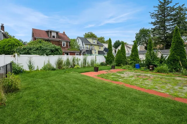 a view of a garden with a building in the background