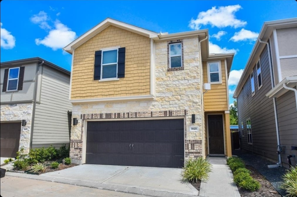 a view of a house with a yard and potted plants