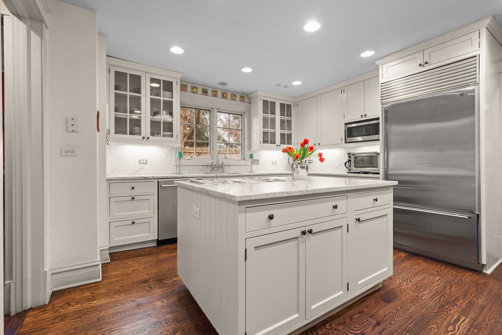 595 Washington Road Lake Forest, IL 60045 - Photo 10 of 28 a kitchen with white cabinets and stainless steel appliances