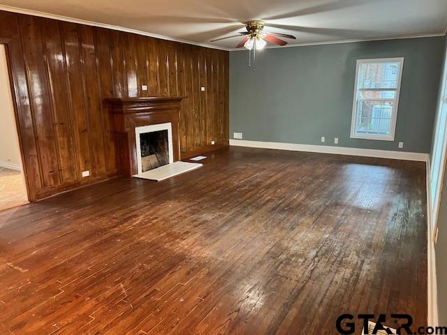 1114 West Camellia Street Tyler, TX 75701 - Photo 2 of 6 an empty room with wooden floor fireplace and staircase