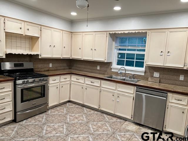 1114 West Camellia Street Tyler, TX 75701 - Photo 4 of 6 a kitchen with granite countertop a stove sink and cabinets