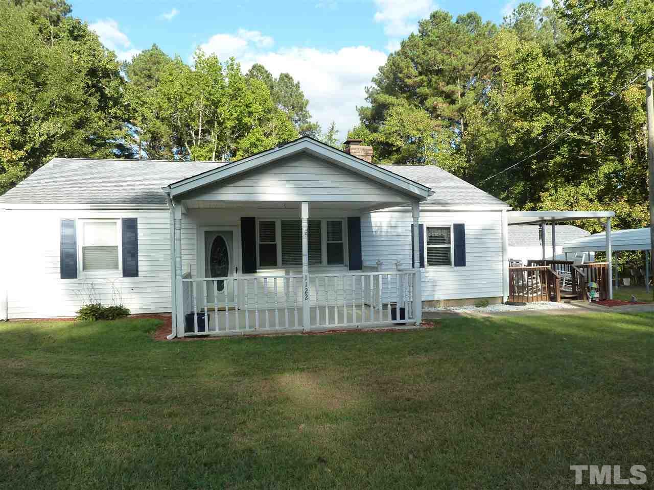 1122 Arvin Road Durham, NC 27704 - Photo 1 of 9 a big white house with a big yard and large trees