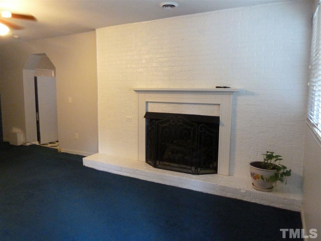 1122 Arvin Road Durham, NC 27704 - Photo 6 of 9 a living room with a fireplace