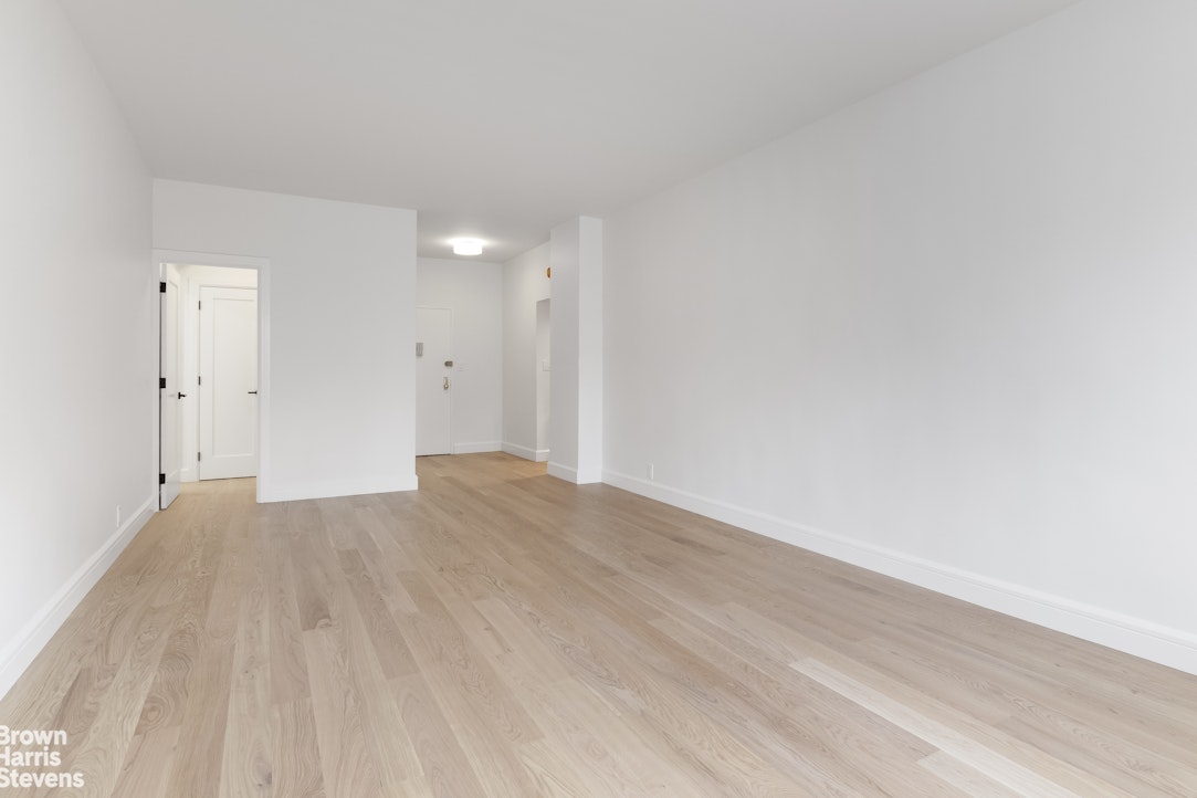 405 East 63rd Street, Unit 10H Manhattan, NY 10065 - Photo 2 of 9 a view of empty room with wooden floor