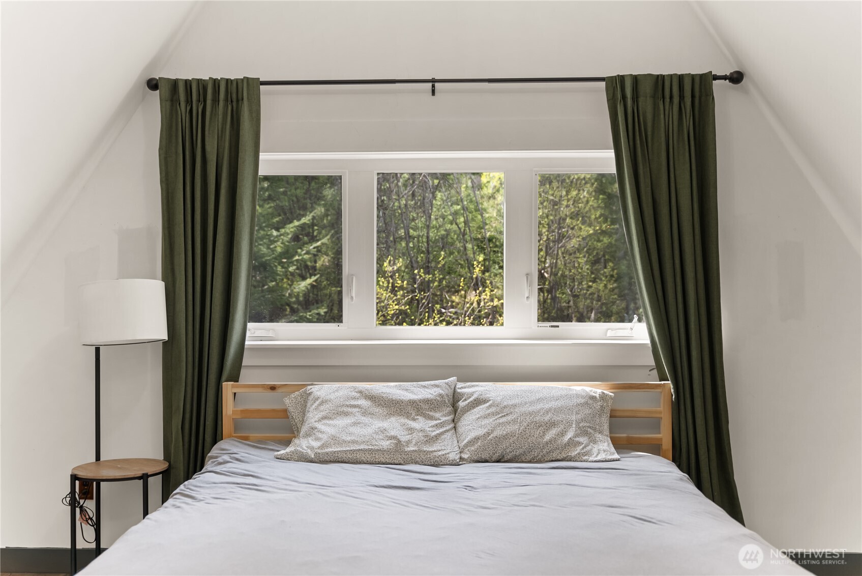 211 West Buttermilk Creek Road Twisp, WA 98856 - Photo 13 of 40 a bedroom with a bed and a large window
