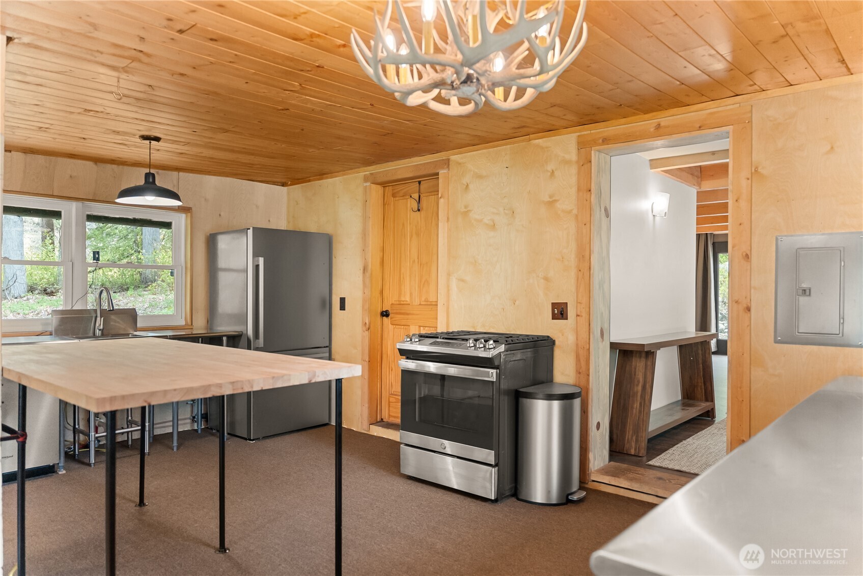 211 West Buttermilk Creek Road Twisp, WA 98856 - Photo 20 of 40 a kitchen with stainless steel appliances granite countertop a stove a refrigerator a kitchen island a stove and a refrigerator