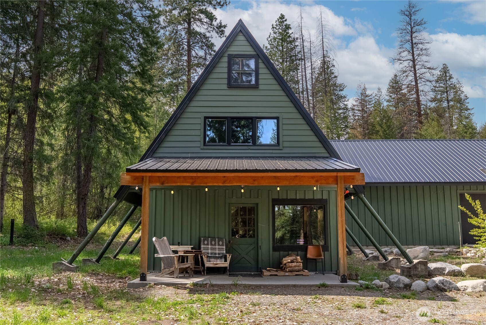 211 West Buttermilk Creek Road Twisp, WA 98856 - Photo 2 of 40 a front view of a house with garden