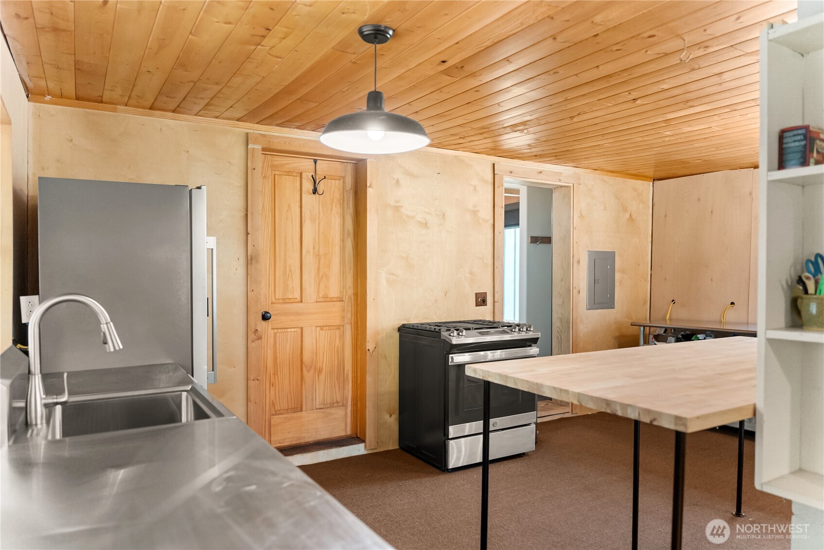 211 West Buttermilk Creek Road Twisp, WA 98856 - Photo 21 of 40 a kitchen with a table chairs and a sink