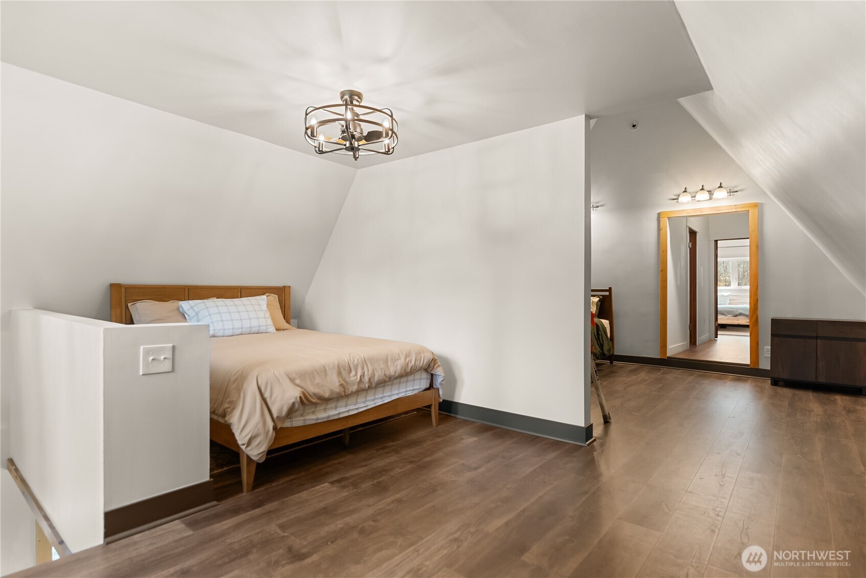 211 West Buttermilk Creek Road Twisp, WA 98856 - Photo 29 of 40 a bedroom with a bed and a chandelier