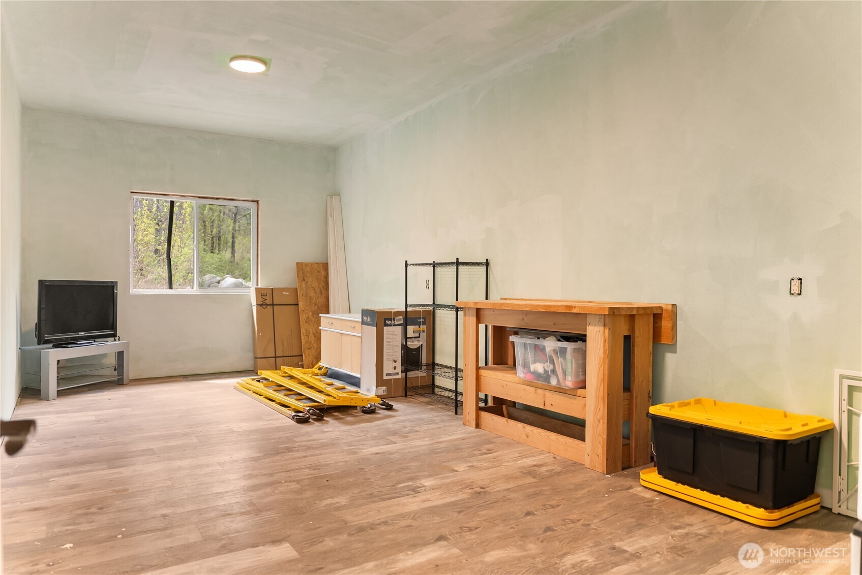 211 West Buttermilk Creek Road Twisp, WA 98856 - Photo 35 of 40 a living room with furniture gym equipment and a flat screen tv