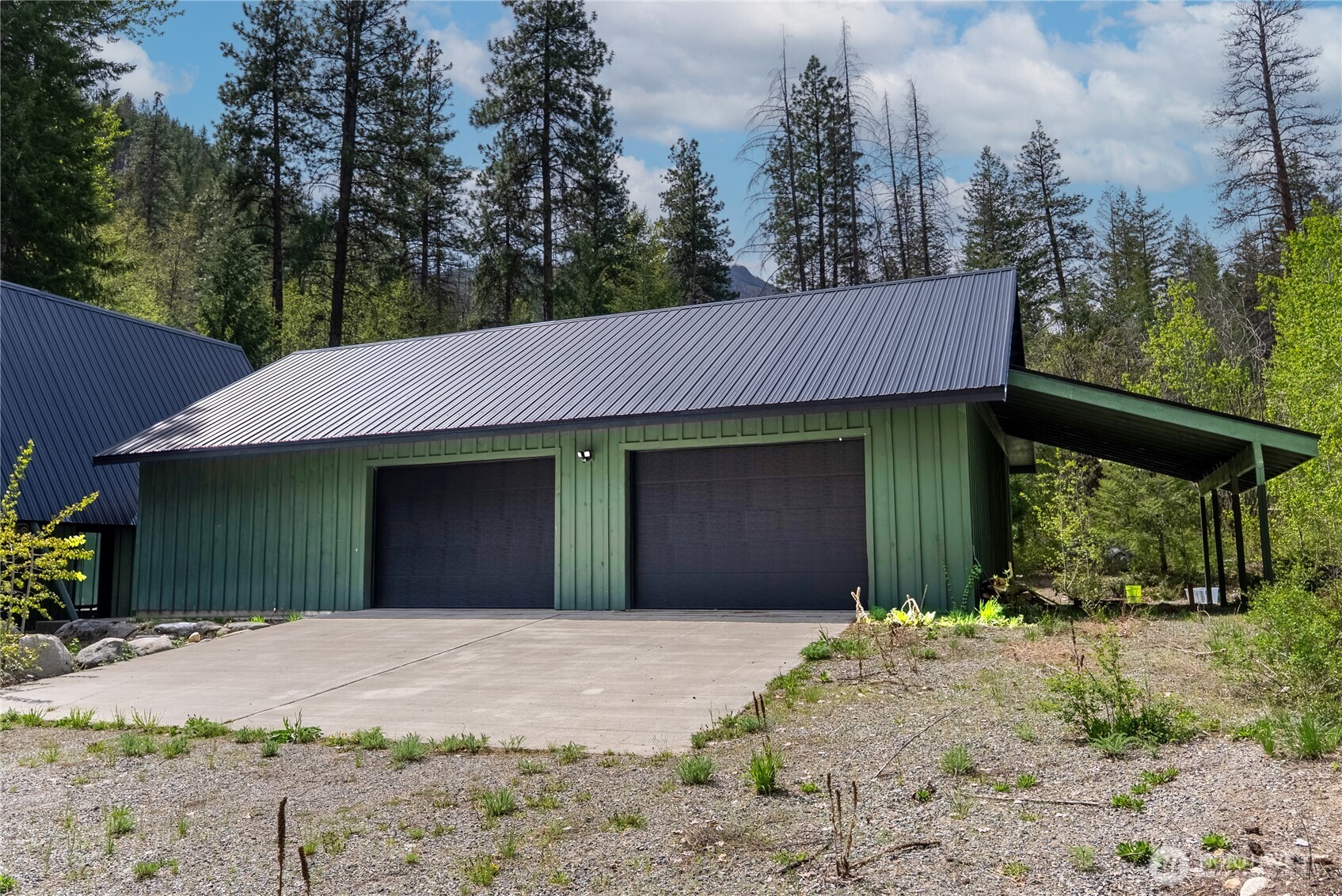 211 West Buttermilk Creek Road Twisp, WA 98856 - Photo 38 of 40 a front view of a house with a yard and garage