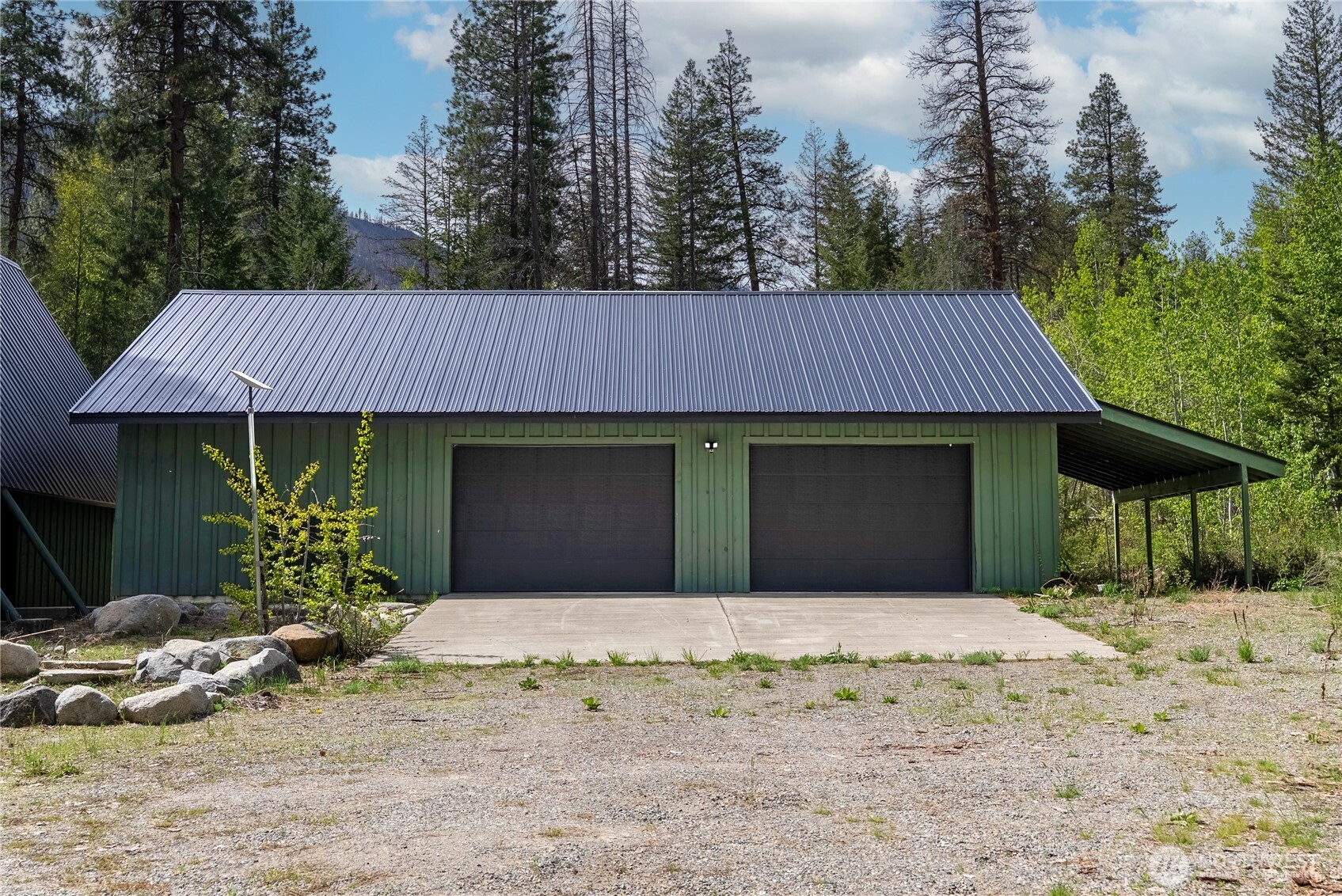 211 West Buttermilk Creek Road Twisp, WA 98856 - Photo 39 of 40 a front view of a house with a yard and garage