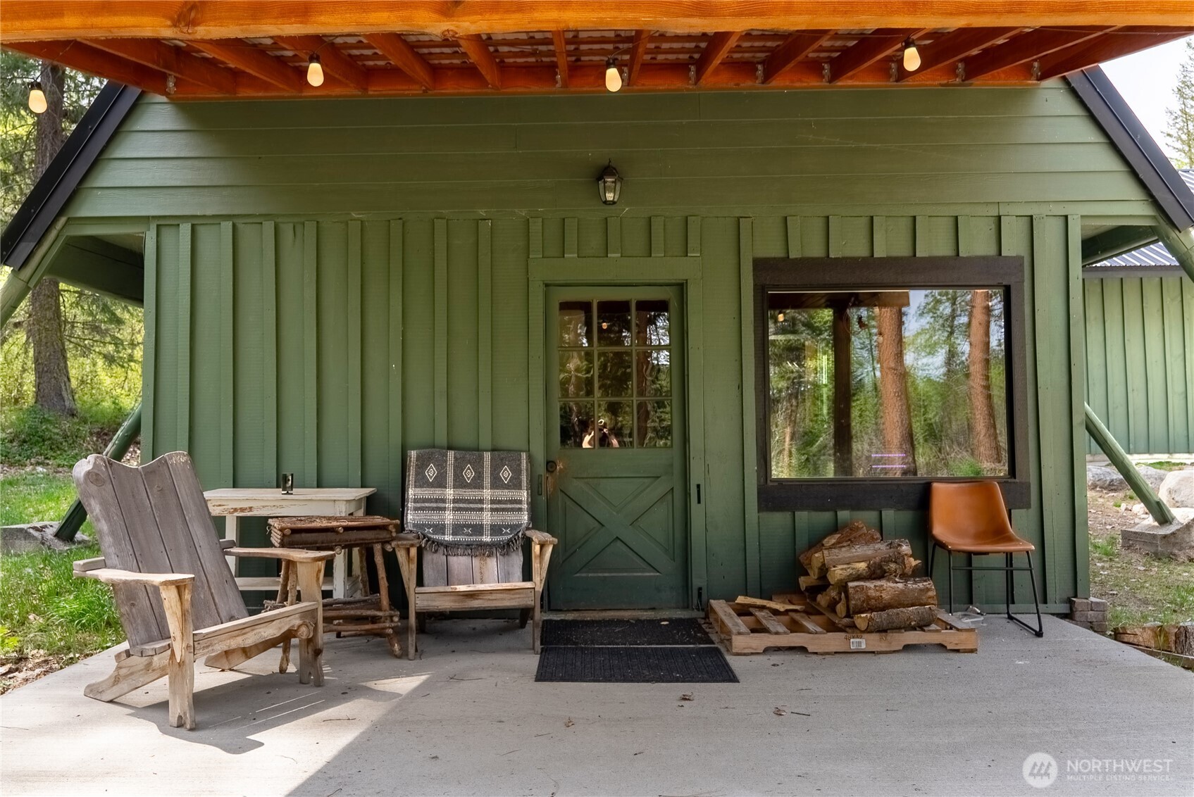 211 West Buttermilk Creek Road Twisp, WA 98856 - Photo 4 of 40 a building outdoor space with patio furniture and potted plants