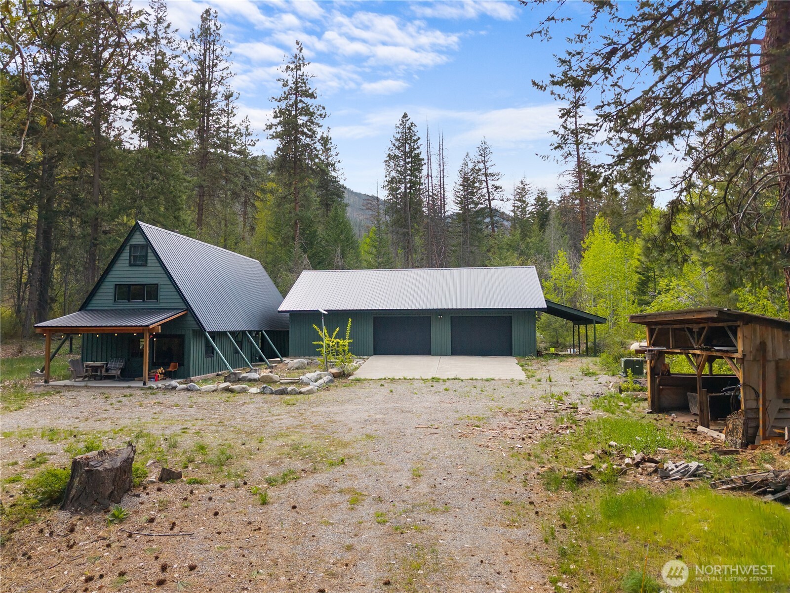 211 West Buttermilk Creek Road Twisp, WA 98856 - Photo 6 of 40 a front view of a house with a yard