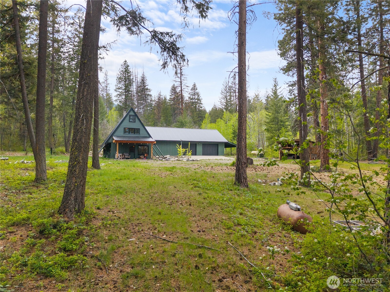 211 West Buttermilk Creek Road Twisp, WA 98856 - Photo 7 of 40 a view of a house with a yard