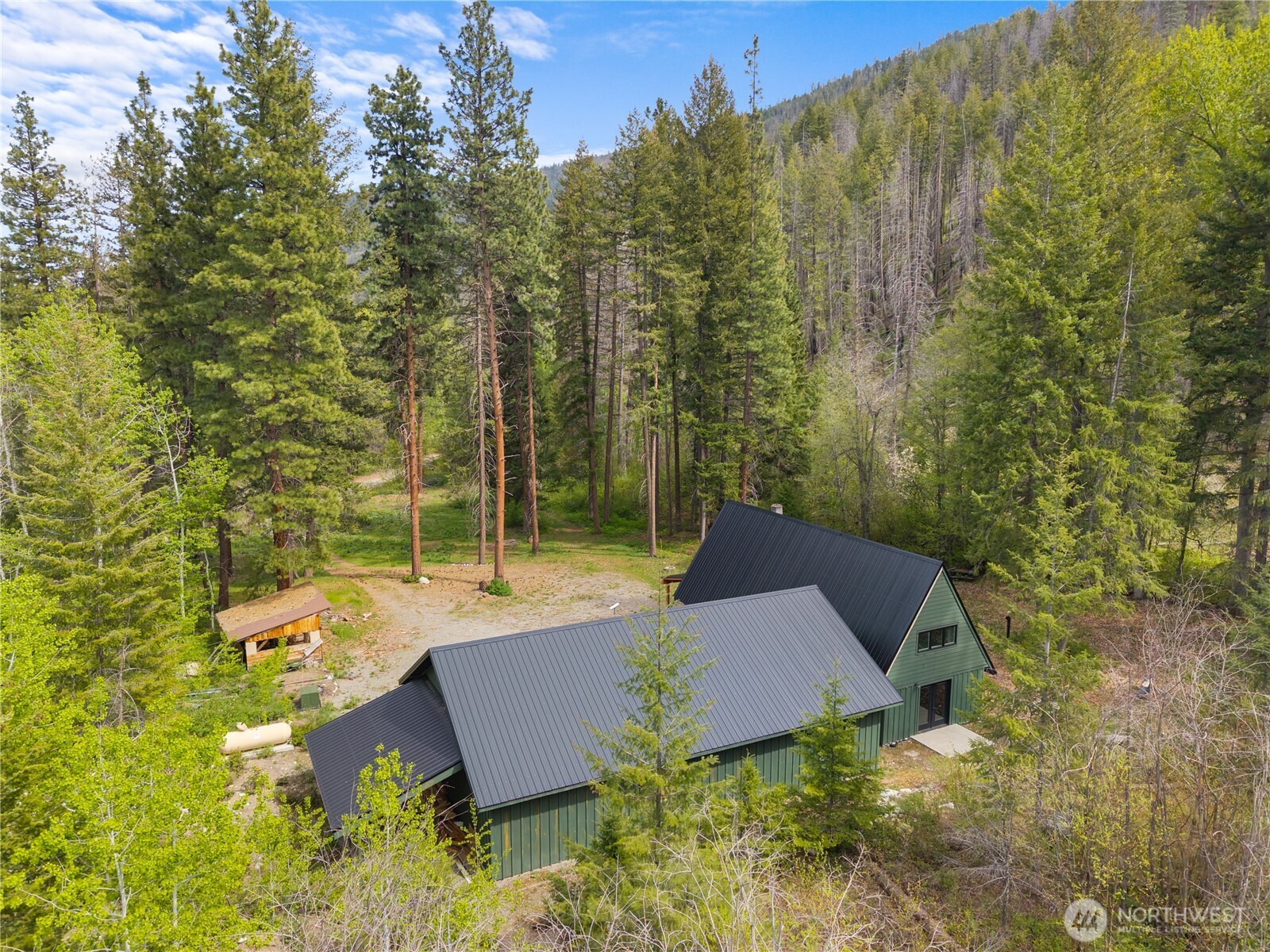 211 West Buttermilk Creek Road Twisp, WA 98856 - Photo 8 of 40 a view of a house with a yard