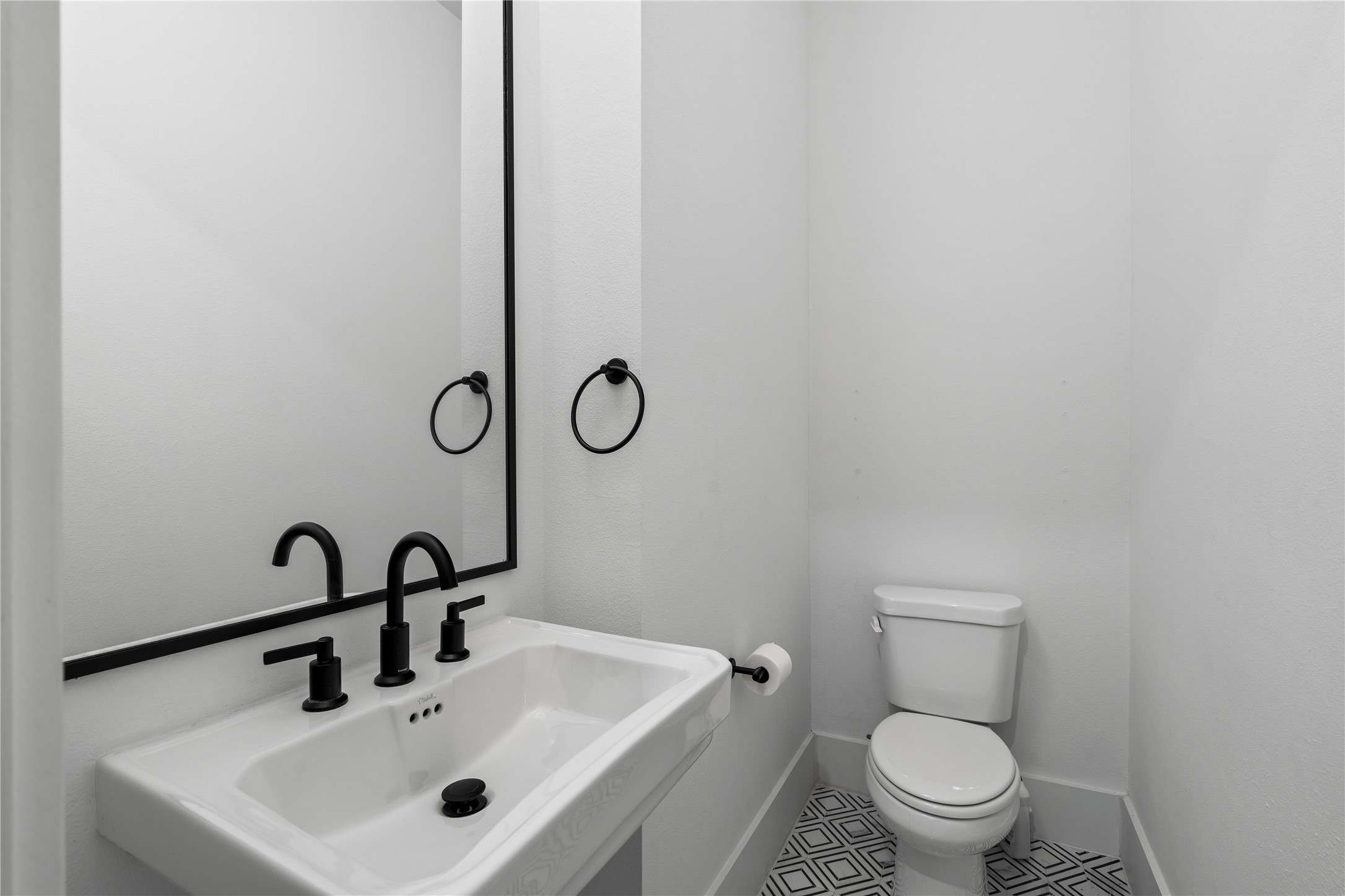9011 Wellspring Drive Houston, TX 77080 - Photo 14 of 24 a bathroom with a toilet sink and mirror