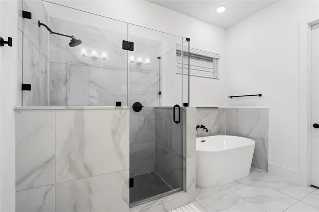 a bathroom with a bathtub and shower