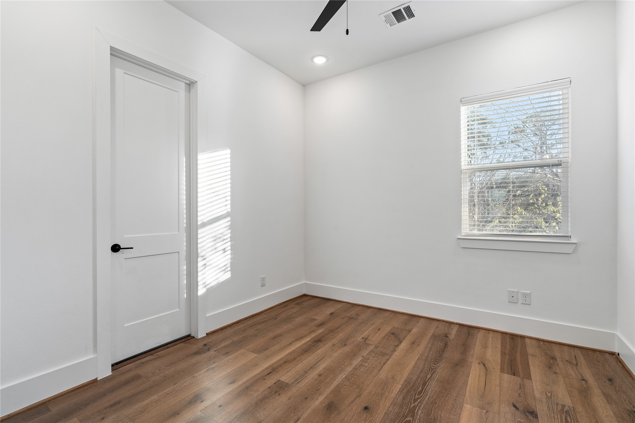 9011 Wellspring Drive Houston, TX 77080 - Photo 20 of 24 an empty room with wooden floor and windows