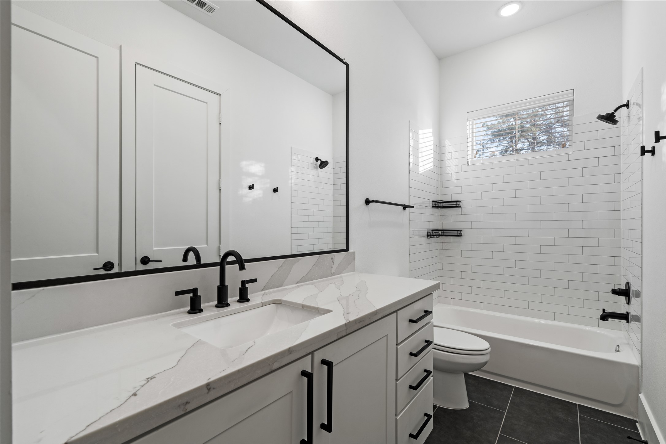 9011 Wellspring Drive Houston, TX 77080 - Photo 21 of 24 a bathroom with a granite countertop sink toilet and shower