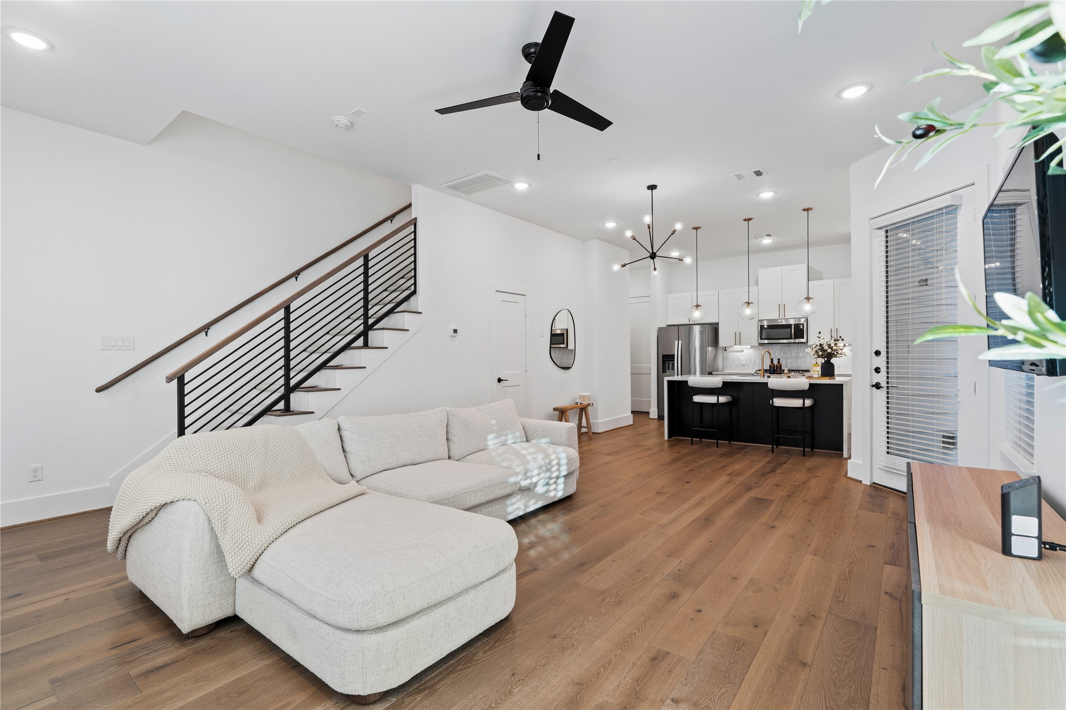 9011 Wellspring Drive Houston, TX 77080 - Photo 7 of 24 a living room with furniture kitchen view and a wooden floor