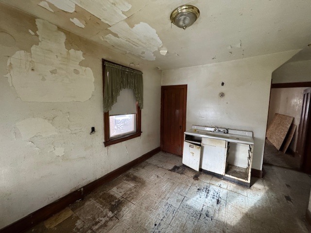 3053 North Kenneth Avenue Chicago, IL 60641 - Photo 4 of 10 a view of an empty room with a fireplace and a window
