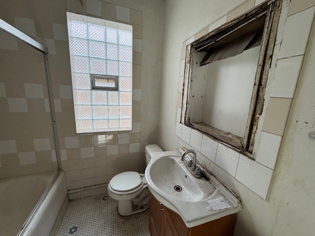 3053 North Kenneth Avenue Chicago, IL 60641 - Photo 5 of 10 a bathroom with a sink toilet and shower