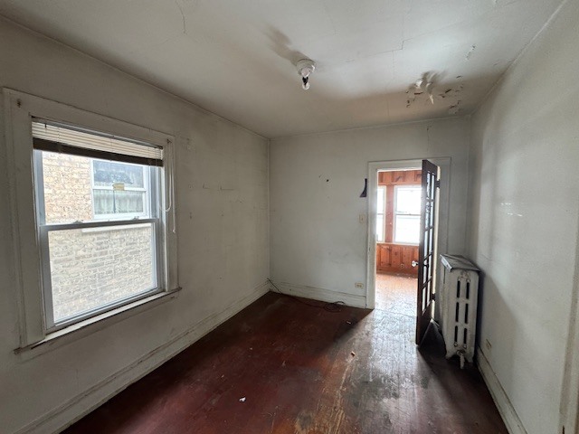 3053 North Kenneth Avenue Chicago, IL 60641 - Photo 6 of 10 wooden floor in an empty room with a window