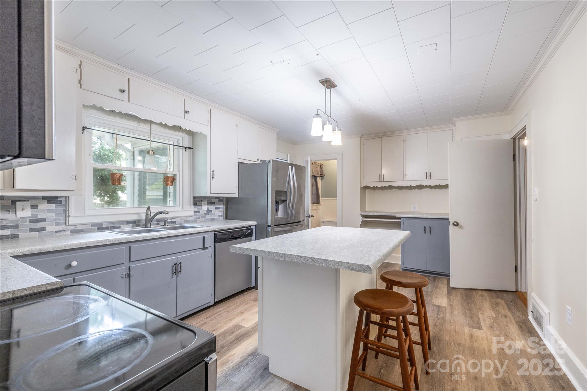 80 Pine Street Badin, NC 28009 - Photo 13 of 42 a kitchen with kitchen island a sink stove and refrigerator